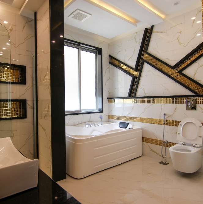 Quakers Hill Bathroom Renovations Contractors Bathroom with a spa bath, gold mosaic feature strips, wall-hung toilet and black accents